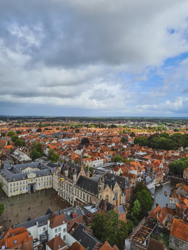 View of several medieval buildings, Burg Square, and the nearby canal in Bruges, Belgium.