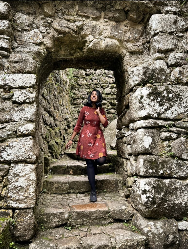 Kiki from RooKiExplorers walking under an arch in the Moorish Castle.