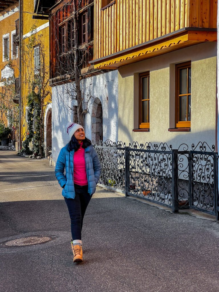Kiki from RooKiExplorers walking in an alley in Hallstatt.
