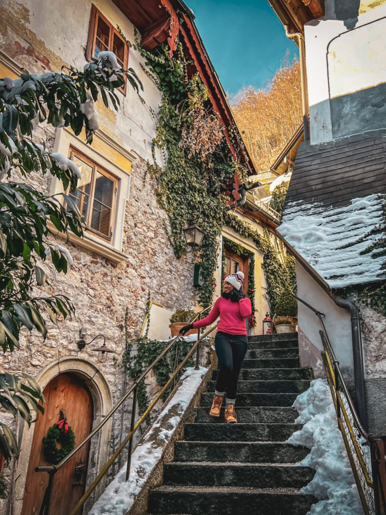 Kiki from RooKiExplorers walking down the stairs in one of the alleys in Hallstatt.