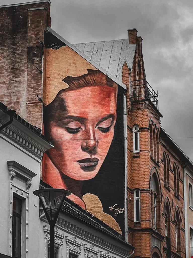An art mural of a woman near Gustav Adolfs Torg in Malmo.