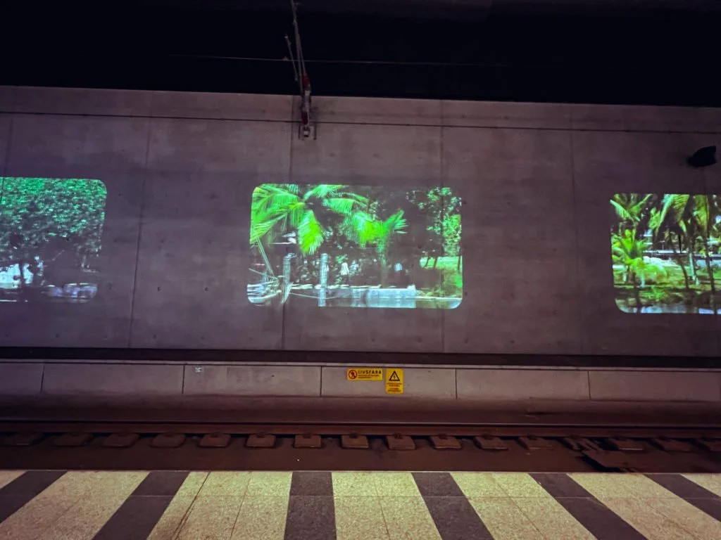 A slideshow of images projected on the wall near an underground train platform in Copenhagen.