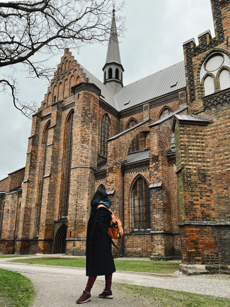 Kiki from RooKiExplorers posing in front of the Saint Peter's Church in Malmo.