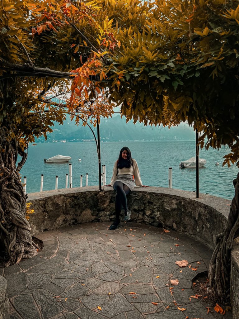 Kiki from RooKiExplorers sitting near the shores of Lake Como in Menaggio.