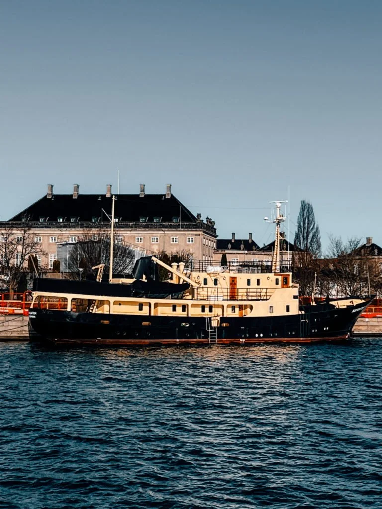A large boat docked at Copenhagen's waterfront.