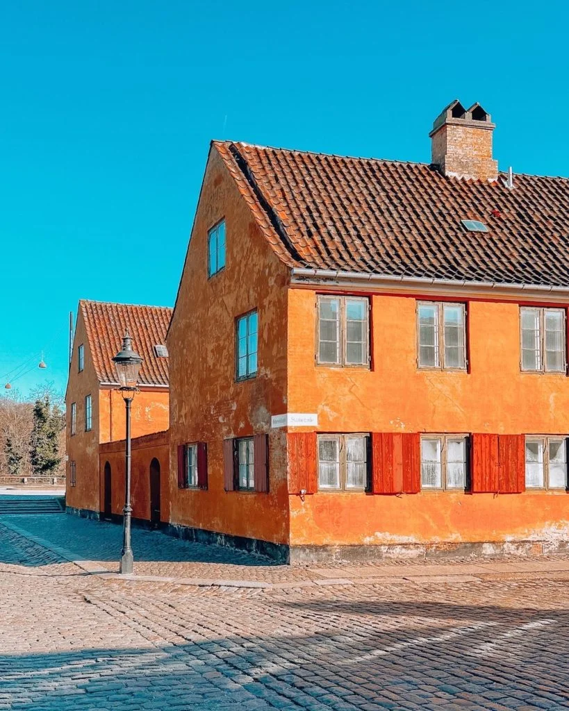A couple of orange colored buildings in Nyboder, Copenhagen.