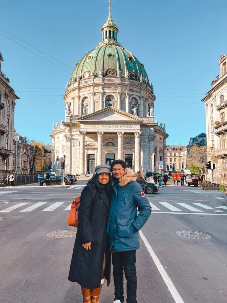 Roopesh and Kiki from RooKiExplorers posing in front of Frederik's church in Copenhagen.
