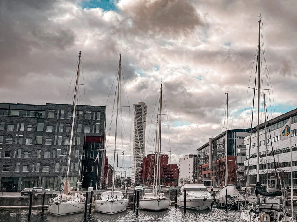 The Turning Torso of Malmo with yachts docked in the harbor.