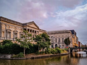 Buildings and trees on a river bank in Ghent.