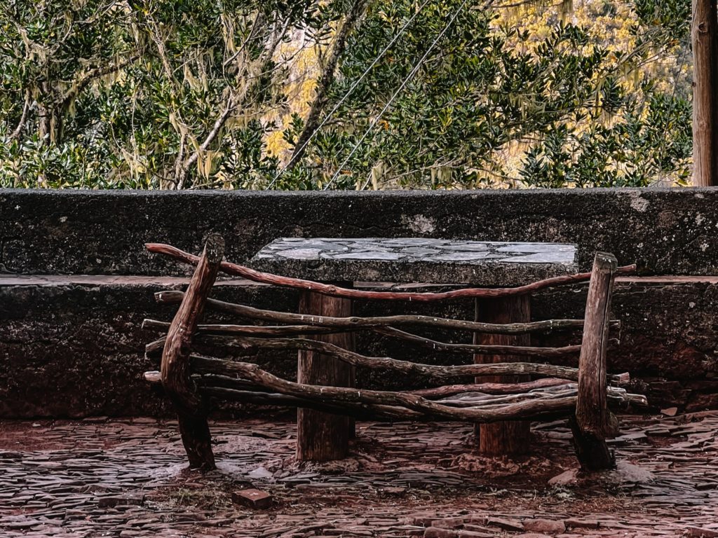 A wooden bench in Rabaçal Nature Spot Cafe in Madeira.