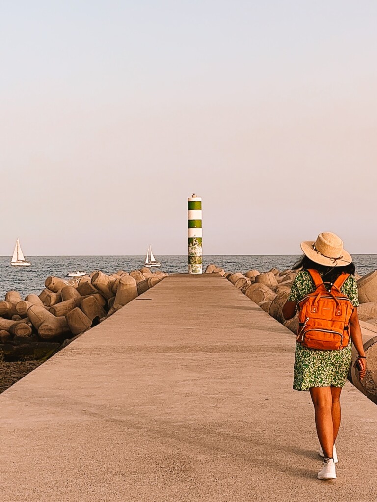 Kiki from RooKiExplorers strolling near the lighthouse of Funchal in Madeira