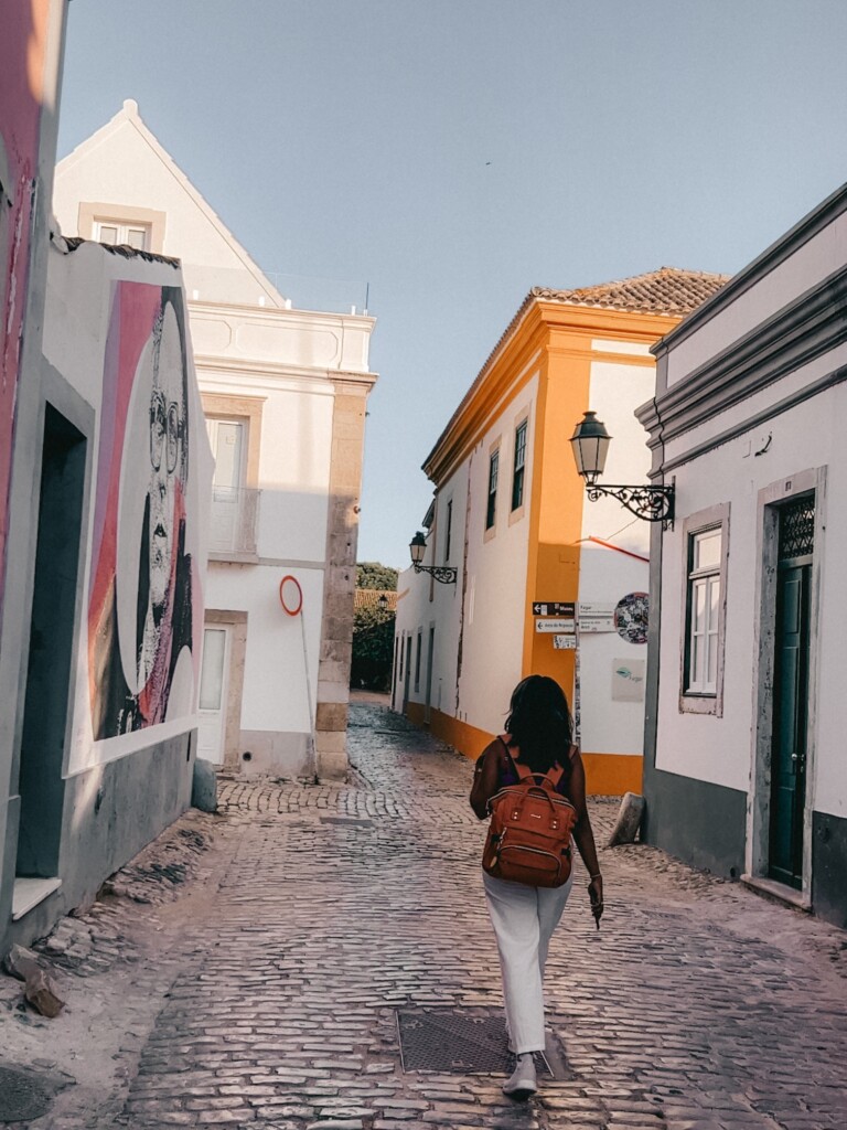 Kiki from RooKiExplorers walking in Rua do Trem in Faro.