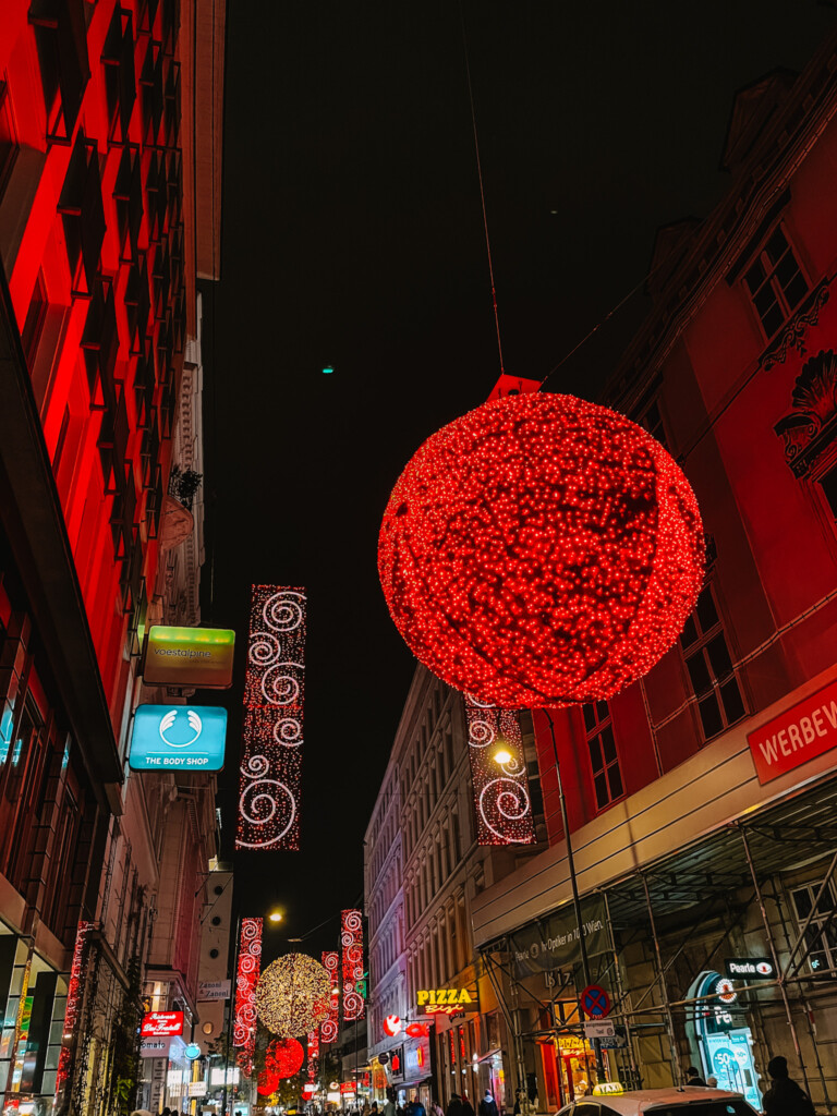 A large red colored bauble Christmas light decoration in Vienna.