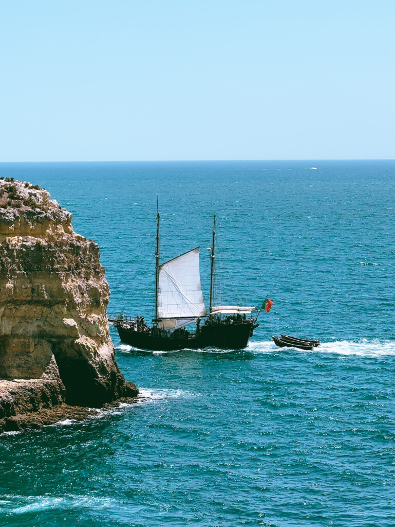 A pirate themed ship sailing near Ferragudo, Algarve.