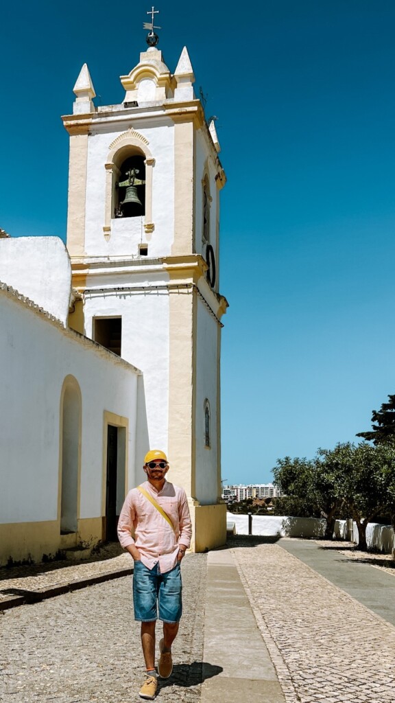 Roopesh from RooKiExplorers strolling near Igreja de Nossa Senhora da Conceição in Ferragudo, Algarve.