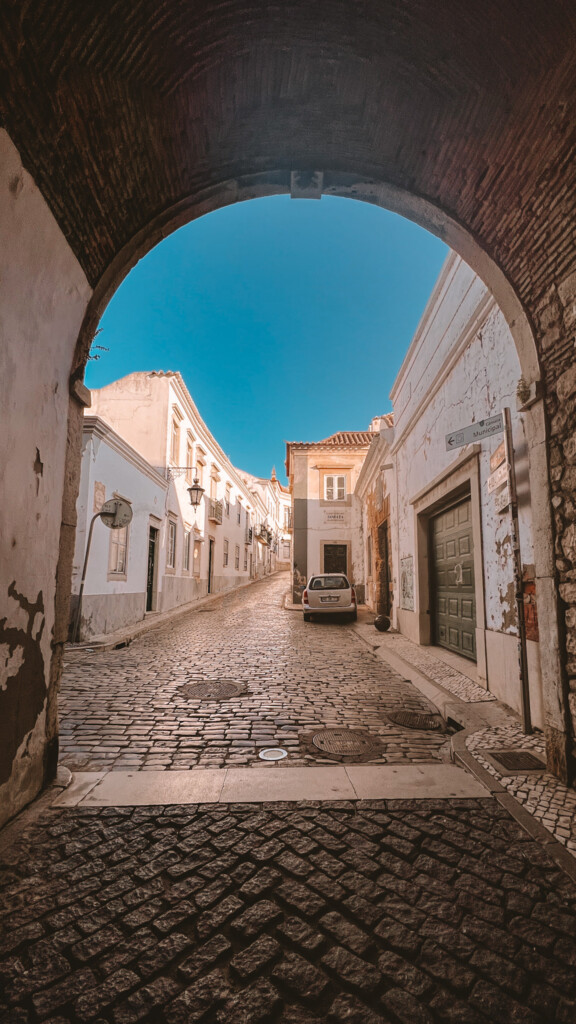The cobbled street under Arco da Vila in Faro.