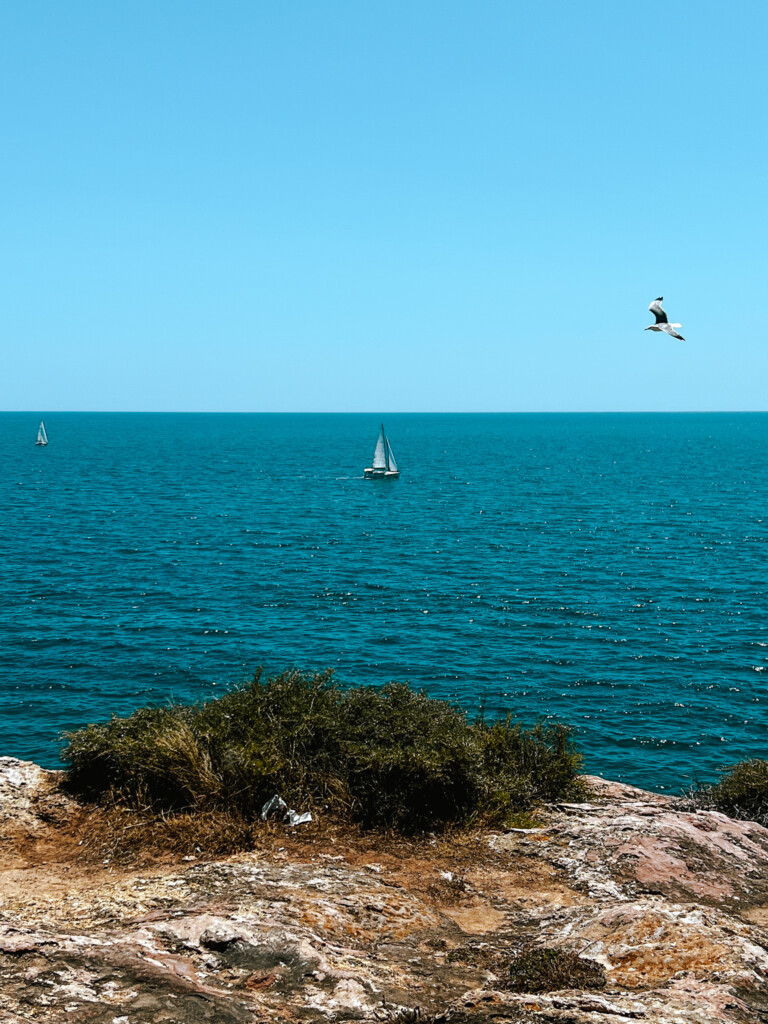 A yacht sailing near Ferragudo, Algarve.