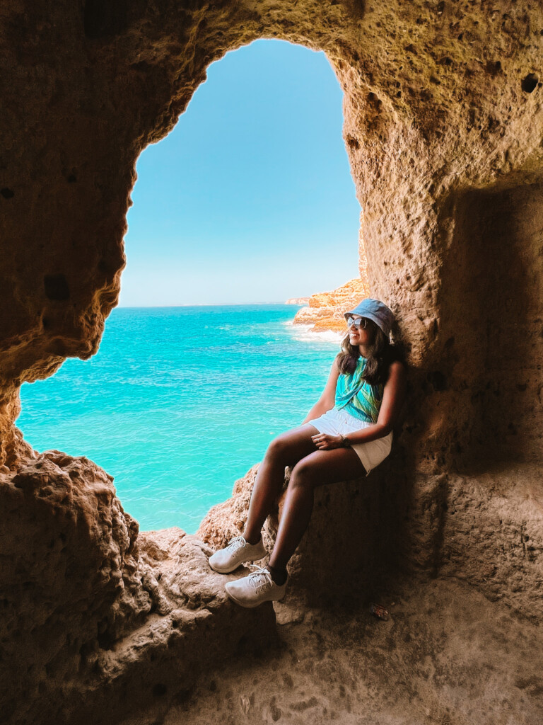 Kiki from RooKiExplorers in a small cave in Algar Seco Rocks in Carvoeiro, Algarve.