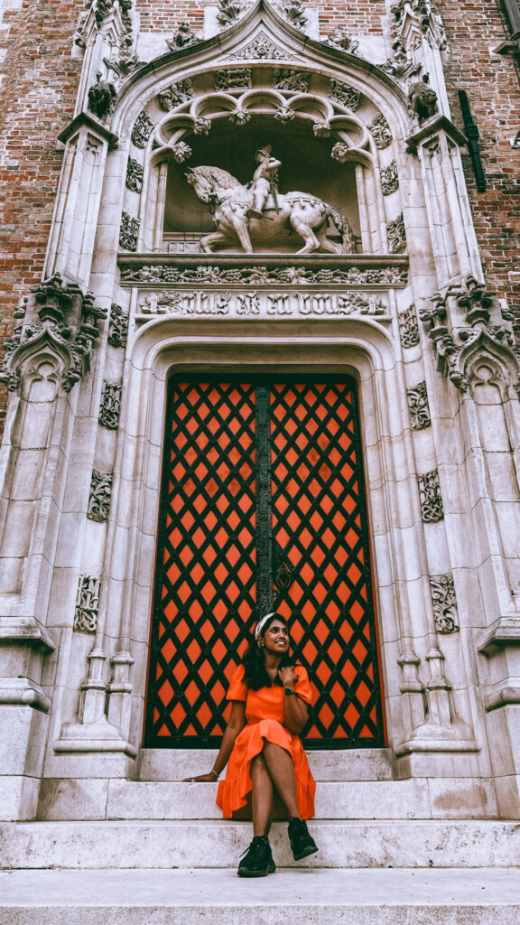 Kiki from RooKiExplorers posing outside the Gruuthuse Museum in Bruges, Belgium.