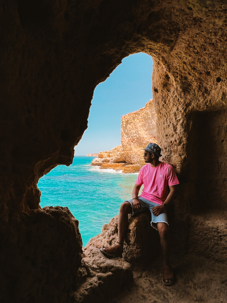 Roopesh from RooKiExplorers in a small cave in Algar Seco Rocks in Carvoeiro, Algarve.