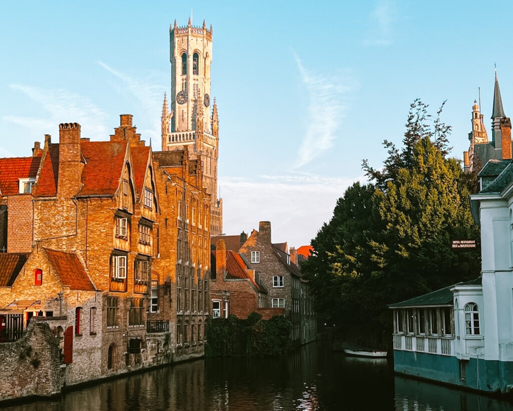 View of the Belfry of Bruges with a canal in the foreground from Rozenhoedkaai in Bruges, Belgium.